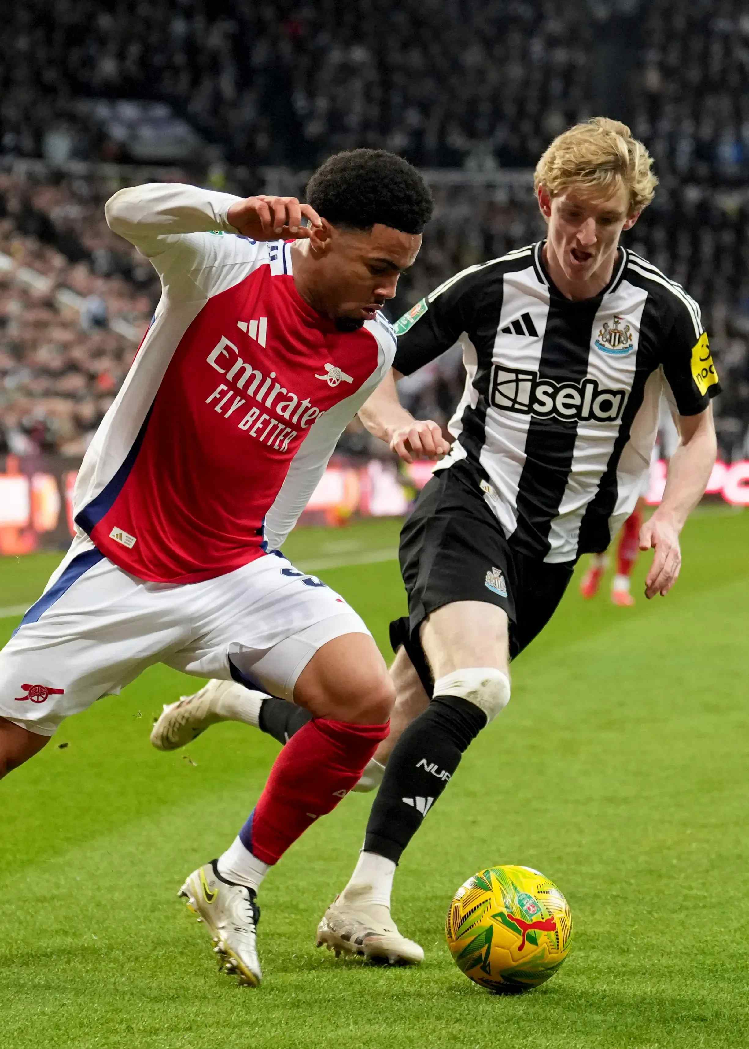 Arsenal's Ethan Nwaneri competes for the ball against Newcastle United's Anthony Gordon
